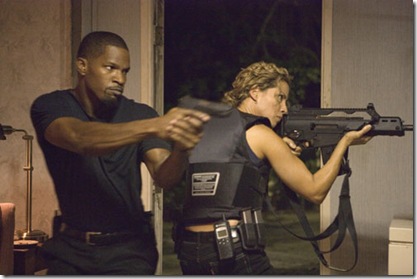 JAMIE FOXX as Detective Ricardo Tubbs and ELIZABETH RODRIGUEZ as Gina Callabrese prepare to take down members of the Aryan Brotherhood in ?Miami Vice?, the feature film crime drama that liberates what is adult, dangerous and alluring about working deeply undercover.  ?Miami Vice? opens on July 28, 2006.