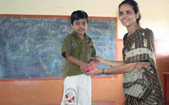 Teacher giving prize to anbarasan