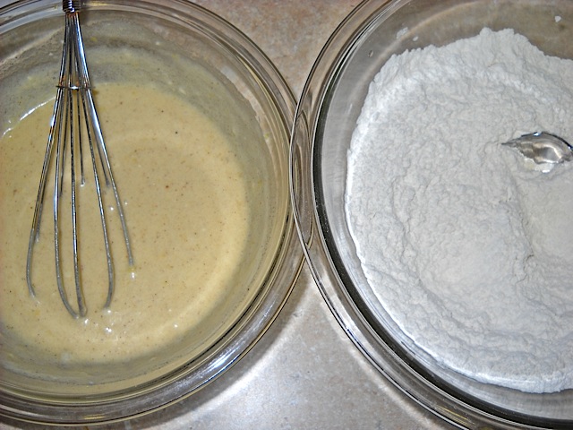 Dry ingredients  in bowl (flour, salt, baking powder) and the wet ingredients (eggs, sugar, butter, vanilla extract, almond extract, cinnamon, nutmeg and zest) in separate bowl.
