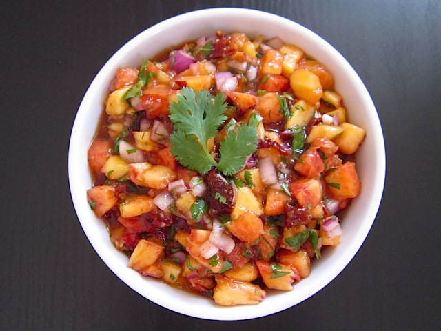 Chipotle Peach Salsa in white serving bowl, garnished with cilantro 