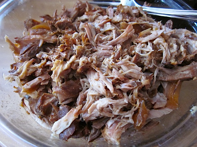 shredded pork in clear mixing bowl 
