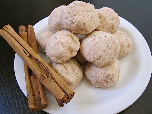 polvorones on white plate with cinnamon sticks on the side 