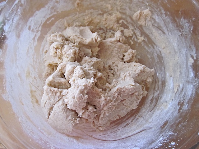 dry ingredients mixed with wet ingredients in clear mixing bowl 