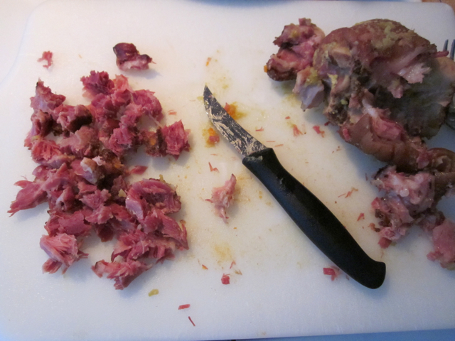 ham hock meat being cut off the bone