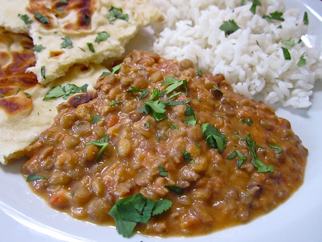 Dal Nirvana with Naan and rice plated on white plate 