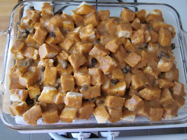 poured custard over bread cubes in baking pan