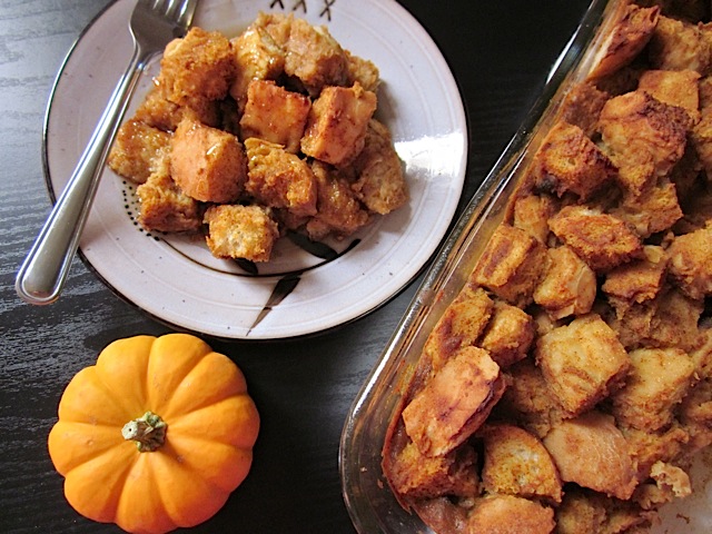 Pumpkin Bread Pudding on plate with fork next to pan of bread pudding 