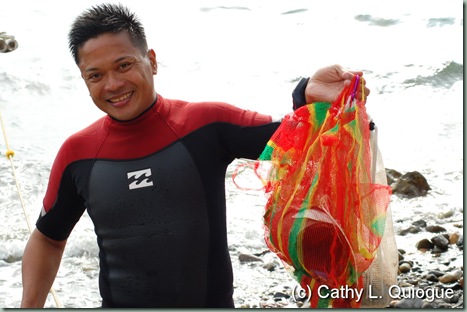 Dive master Butch Javier with his finds