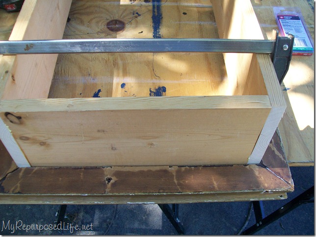 a bar clamp holds the thrift store frame shadow box together a bar clamp holds the thrift store frame shadow box together