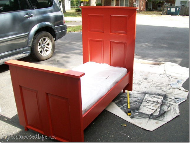 toddler bed made from a door using a crib mattress