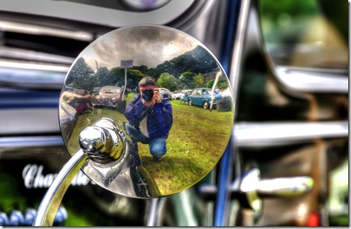 photographer's reflection in the back of a classic car mirror copy