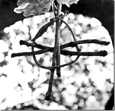 handmade pagan symbol hanging on tree