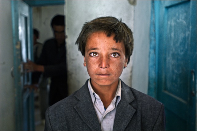 His family is poor, his clothes used. But 15-year-old Ali Aqa isn't deterred: He plans to be a lawyer. Childhood memories include Taliban occupation of his village in Bamian. "They burned everything, even my school," he says. "I pray to God no regime comes like that again." Bamian, Afghanistan. 2007.National Geographic, February 2008, Hazaras.final print_milan
