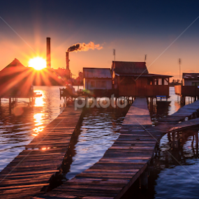 Sunset fishing houses on a lake in Bokod by Zoltan Duray - Landscapes Waterscapes