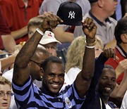 Cleveland Cavaliers' LeBron James holds his New York Yankees hat during the fourth inning of Game 1 of an American League Division Series baseball game between the Yankees and Cleveland Indians Thursday, Oct. 4, 2007, in Cleveland. (AP Photo/Amy Sancetta)