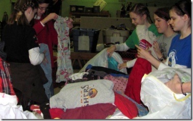 sorting donated clothes