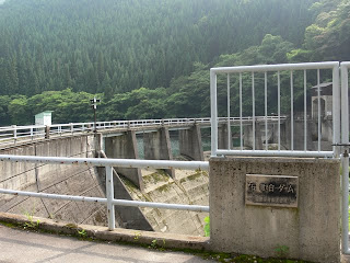 View of the dam nameplate and embankment from the right bank