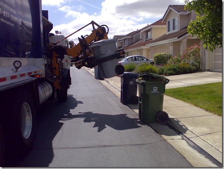 truck lifting the bin with a motorised attachment
