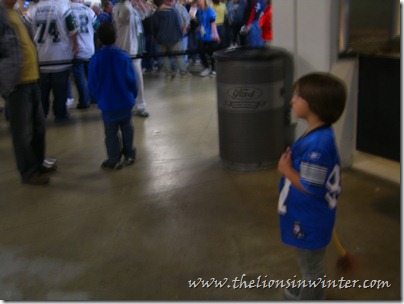 Sad little Lions fan watching the Jets fans congregate.
