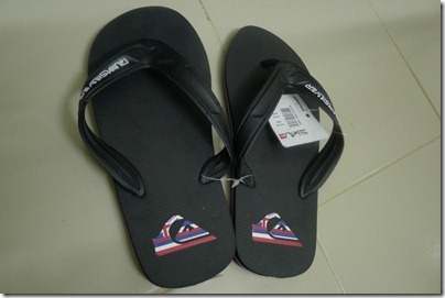 pair of black Quiksilver flip flops