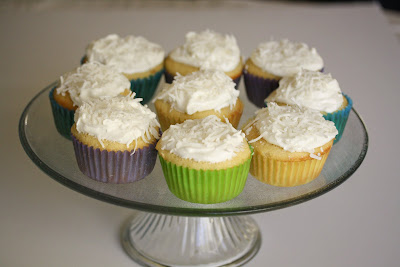 photo of coconut cupcakes on a cake stand.