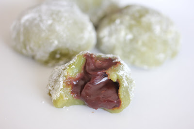 close-up photo of green tea mochi with a chocolate center