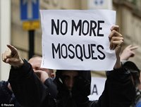 Protester with 'NO MORE MOSQUES' sign