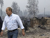 Putin visits fire site