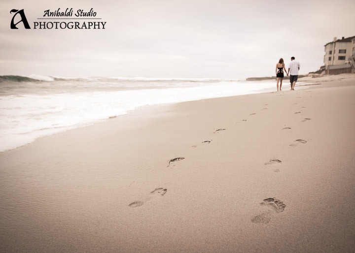 beach footprints engaged couple