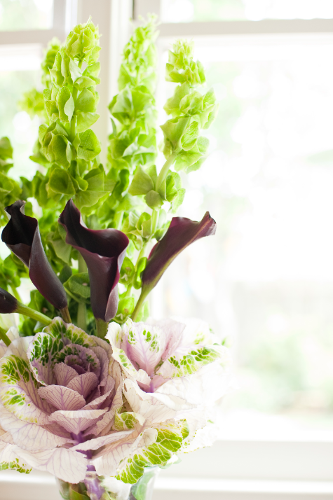 [black cala lilies bells of ireland and pink cabbage arrangement[3].png]