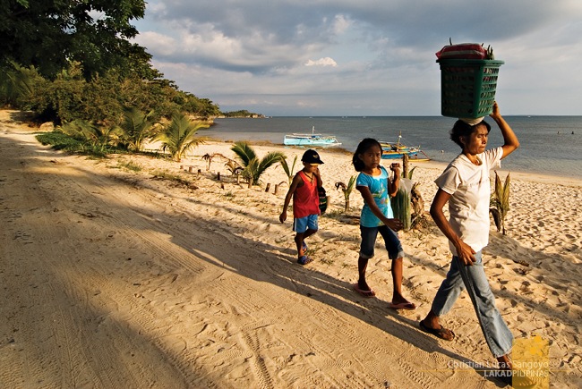 A Family Heading Off with their Wares at Tambobong Beach