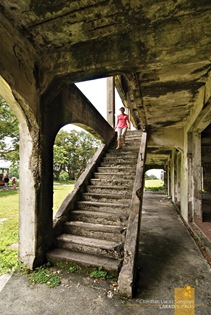 A Visitor Exploring the Second Floor at Corregidor's Mile Long Barracks