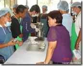 AQD scientist Ms. Myrna Teruel (in violet) supervising the trainees during feed preparation