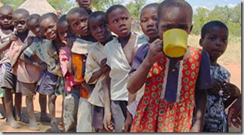 Children line up for a meal at a CARE supplementary feeding program in Masvingo province, Zimbabwe. 