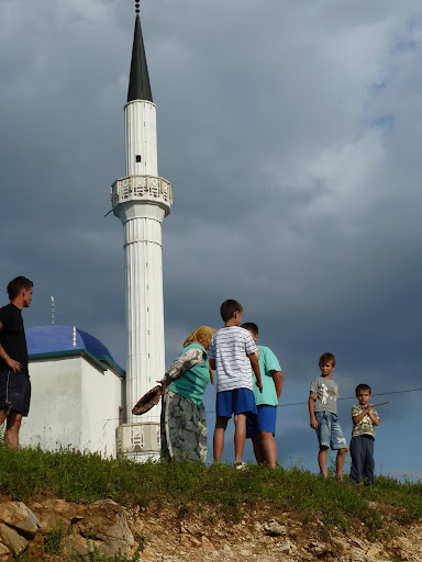 In front of mosque, children watch the march In front of mosque, children watch the march