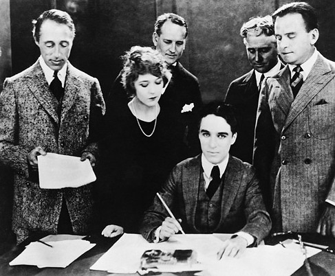 Chaplin signs the contract to establish United Artists