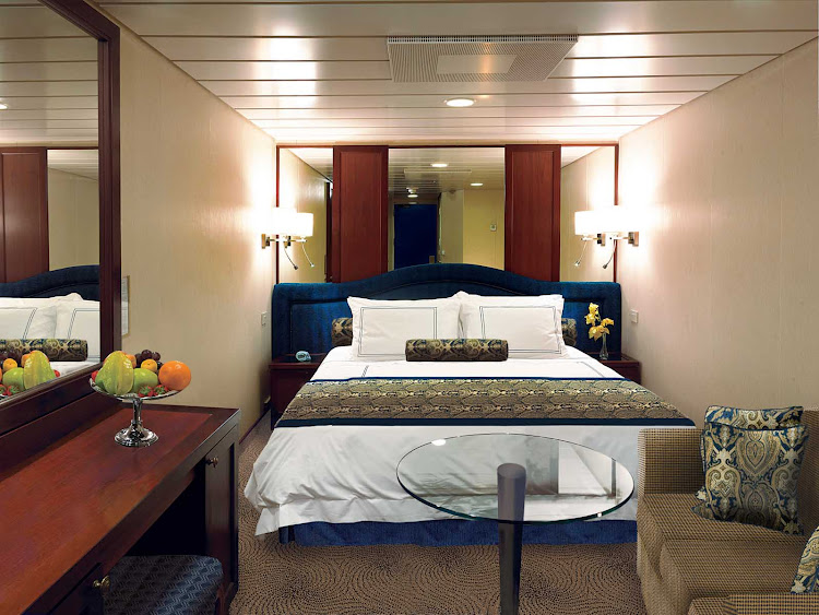 Inside staterooms on Oceania Nautica contain a queen bed with 1,000-thread-count linens, seating area, vanity desk, refrigerated mini-bar, breakfast table, Bulgari amenities, flat-screen TV with live satellite and twice-daily maid service.