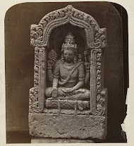 Four-armed Shiva in a niche, holding a rosary and a flywhisk.