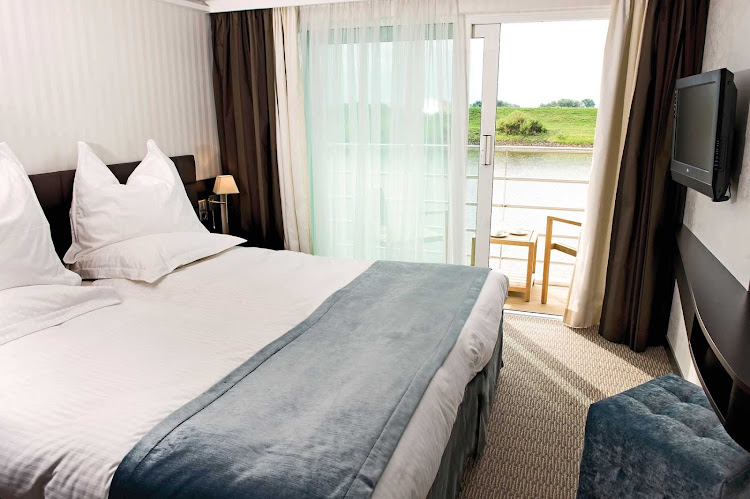 Guests aboard a Scenic Cruises river cruise can enjoy the passing landscapes from a private balcony only steps away from their beds.