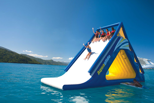 Kids go slip sliding into the warm Caribbean waters of Labadee, Haiti, during an Allure of the Seas cruise.