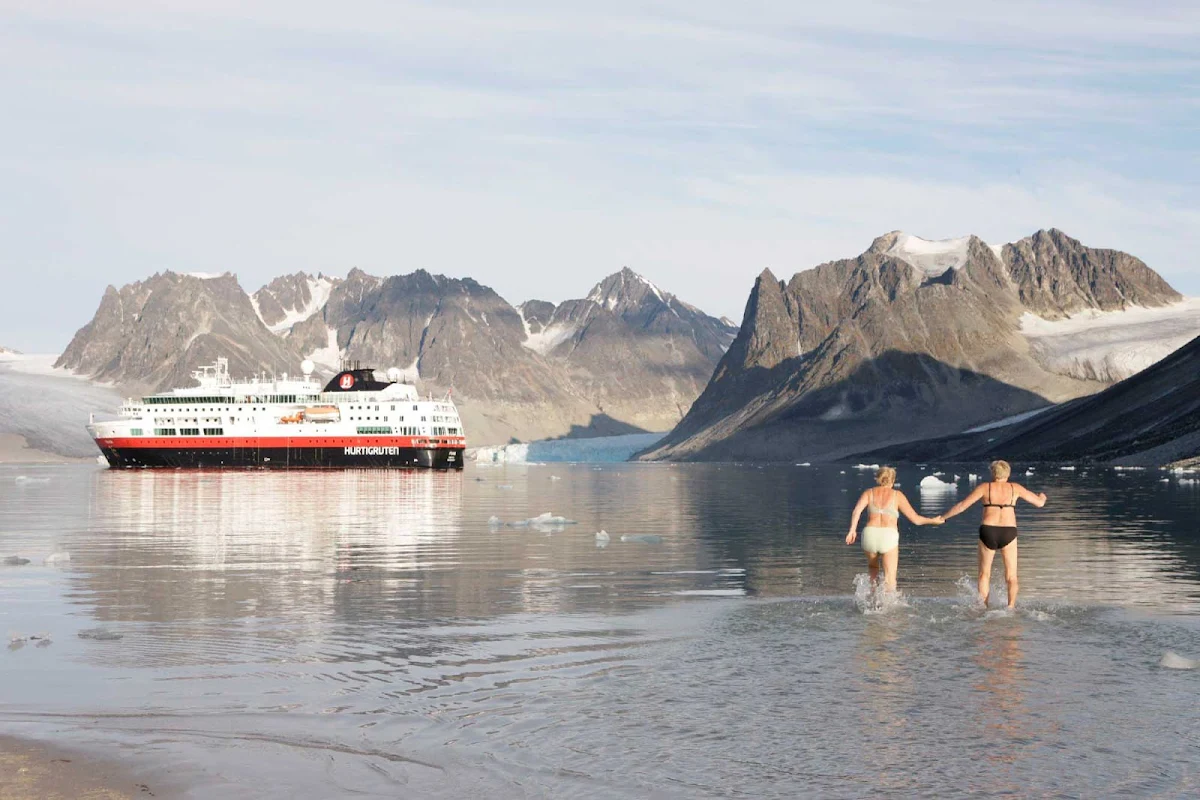Hurtigruten-swimming-in-arctic - Take an afternoon dip in the Arctic Ocean — or just watch human polar bears in action — as you cruise the Svalbard Islands on board Fram, Hurtigruten's flagship.