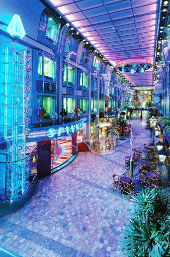 Voyager-of-the-Seas-Royal-Promenade - The Royal Promenade, a four-story entertainment, shopping and dining area, is the hub of Voyager of the Seas.