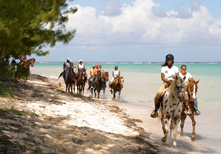 Horseback riding on Barkers Beach on Grand Cayman Island.