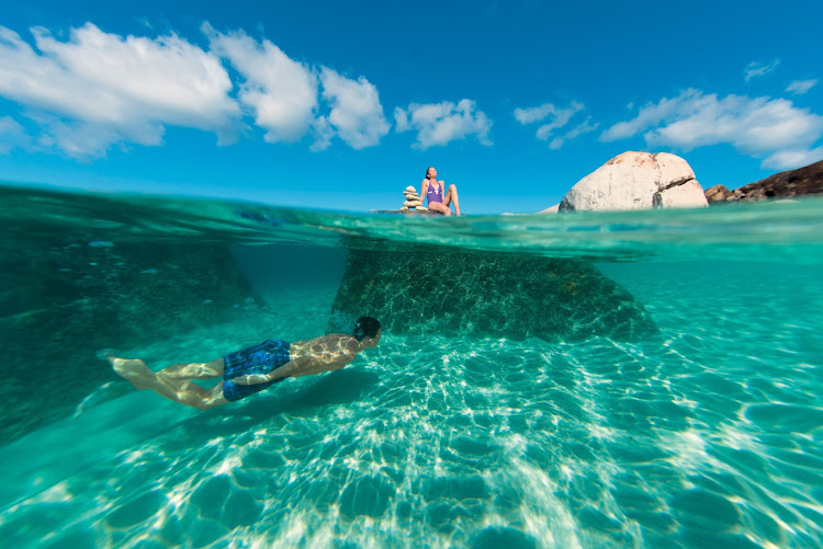 Snorkel, swim or sunbathe at a pristine lagoon in Virgin Gorda, British Virgin Islands.