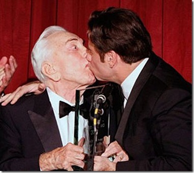 john travolta kisses a man