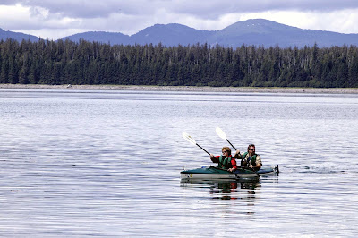 Glide through peaceful waters in a double kayak in Glacier Bay National Park, Alaska.