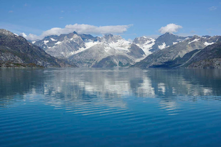 A glacier reflects in the waters of Glacier Bay National Park, Alaska