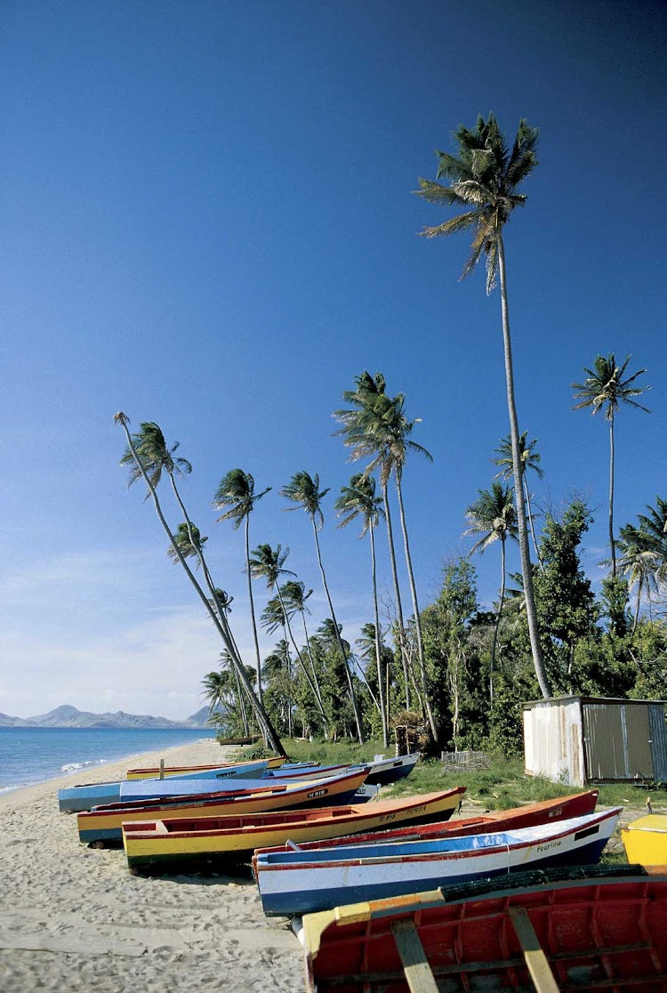 Fishermen's boats line a beach on Nevis.