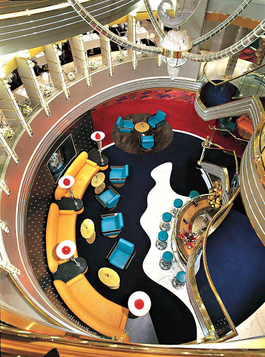This is a view looking down to a spiral open space from the atrium staircase aboard Holland America Line's Zuiderdam.