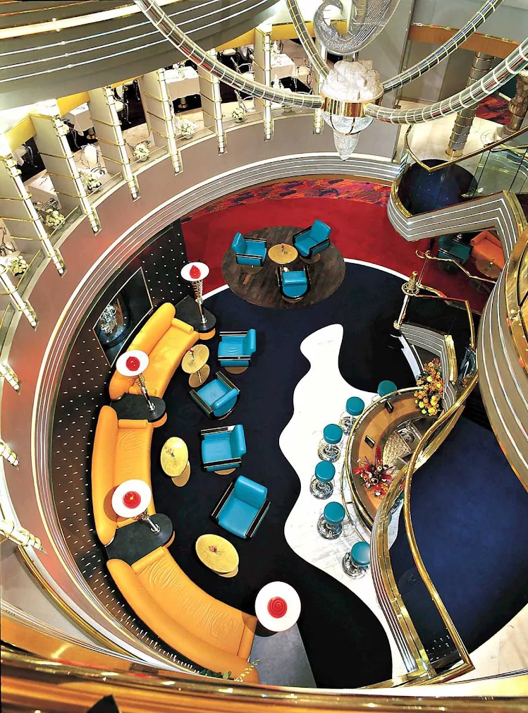This is a view looking down to a spiral open space from the atrium staircase aboard Holland America Line's Zuiderdam.